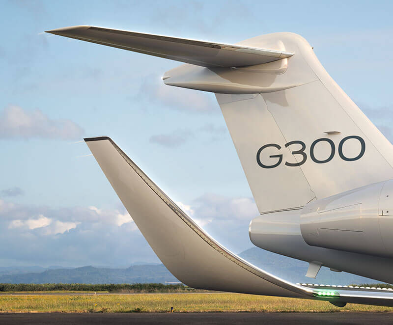 A partial image of a Gulfstream G300 in Gulfstream livery, showing the empennage and sleek winglet.
