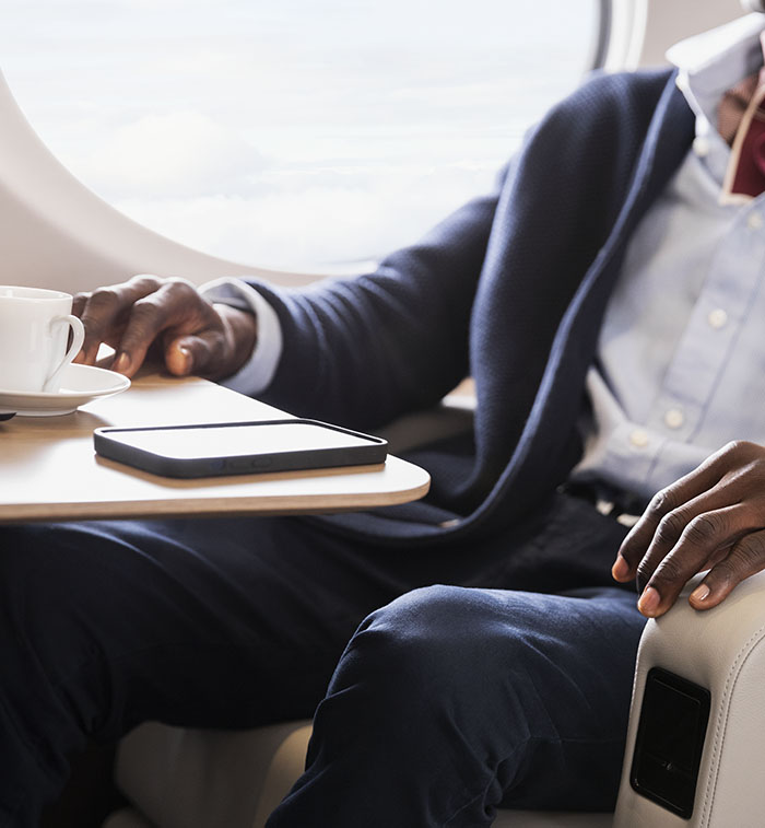 A fashion executive reclines in a G400 chair before a productive workspace lit by a large panoramic window.