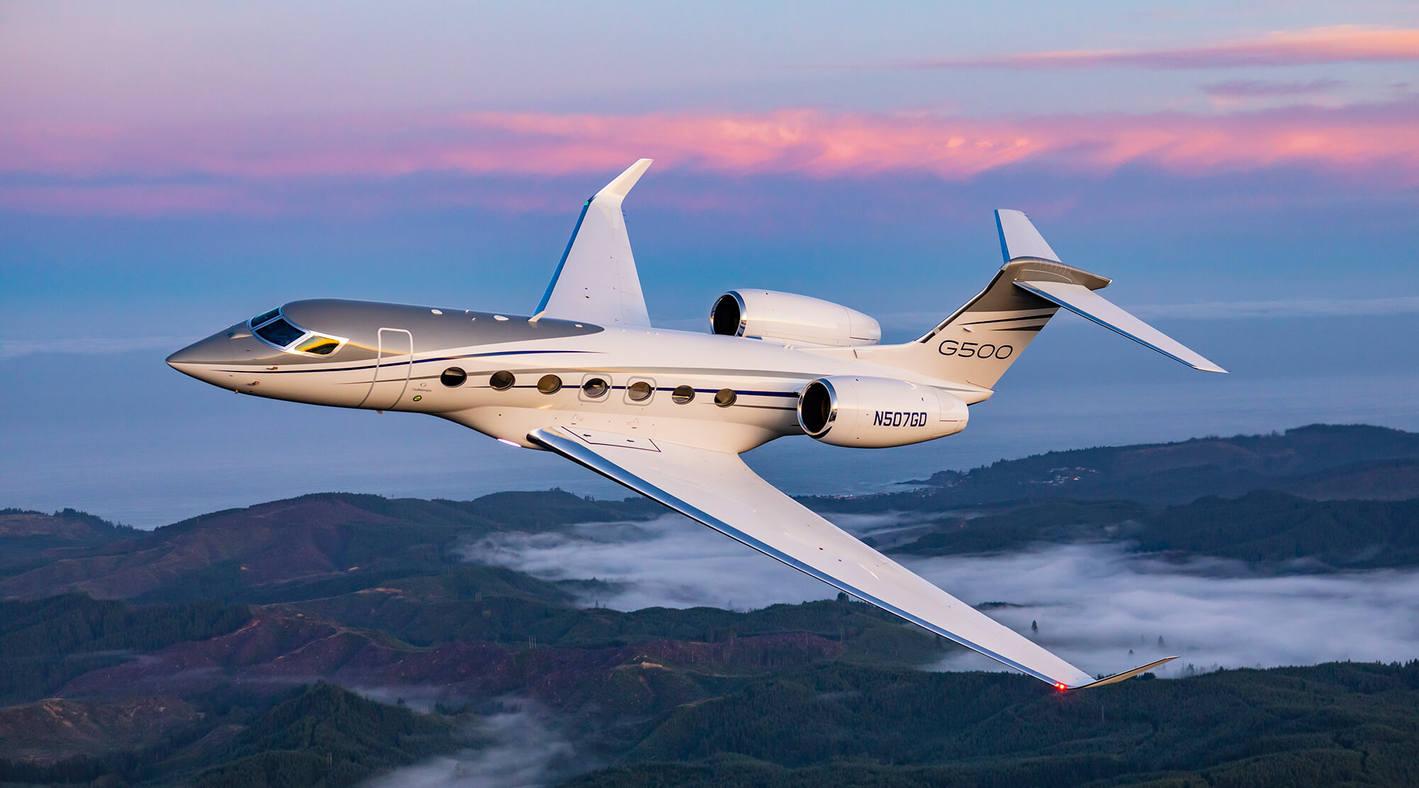 G500 aircraft flying above mountainous terrain
