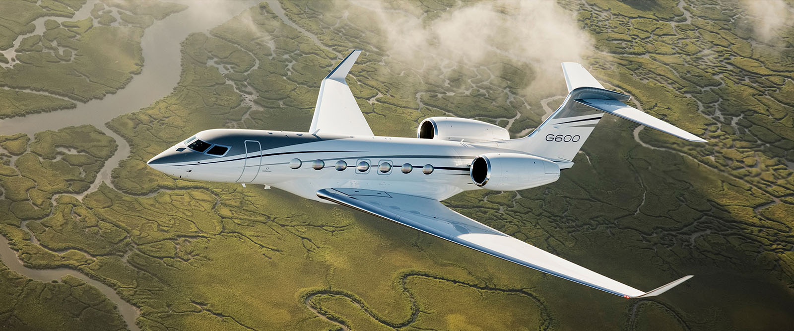 G600 ascends over a verdant river delta