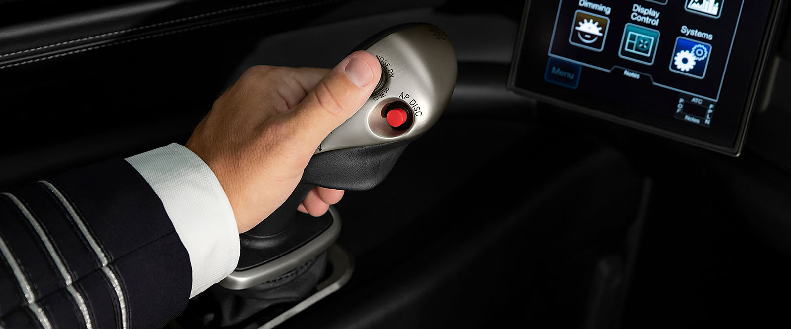 Detail image of a pilot using an active control sidestick in a G600 flight deck