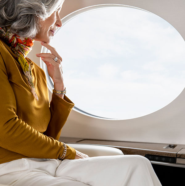 Woman in fashionable and professional attire gazes out a bright G700 panoramic window