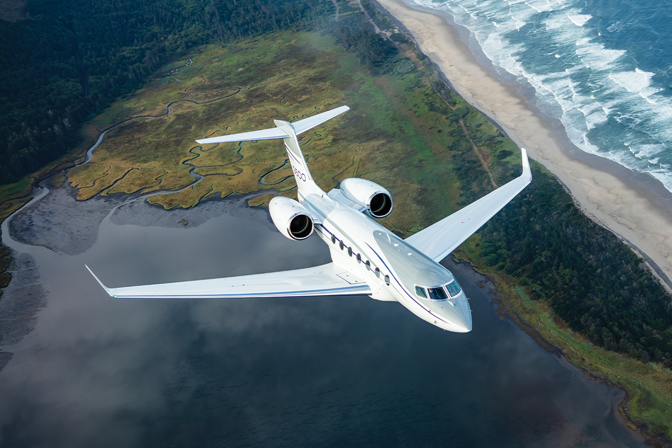 G500 flying over a green peninsula
