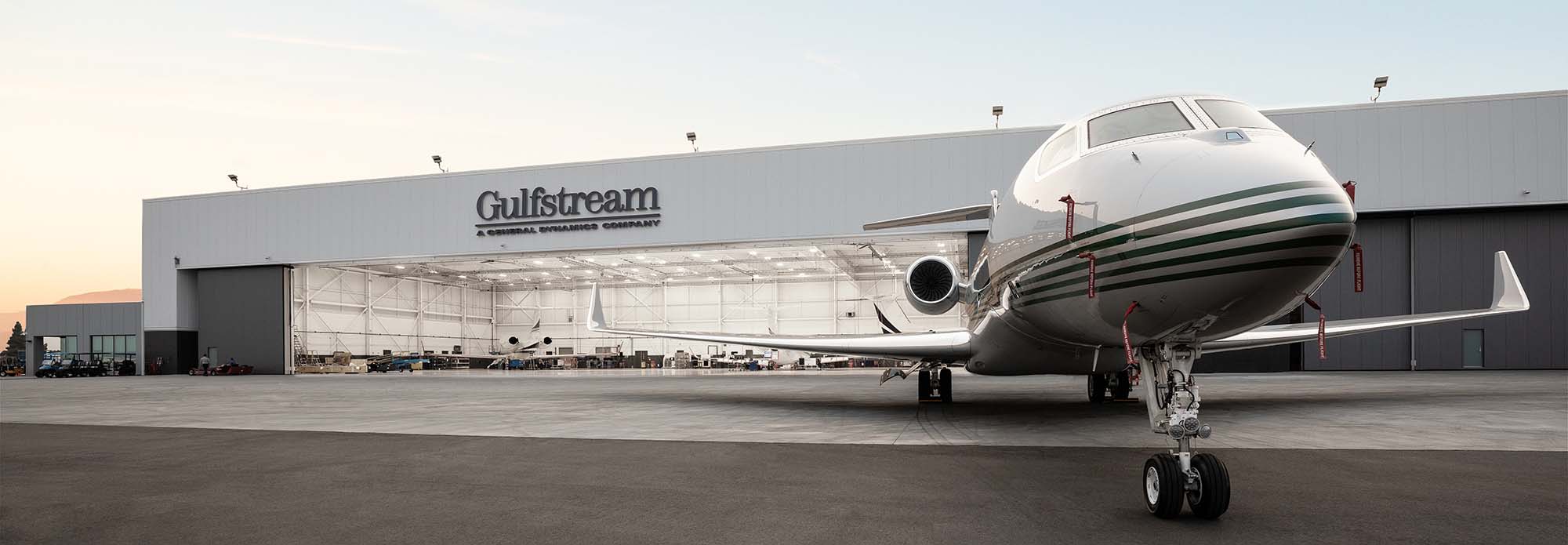 A one-quarter view of a Gulfstream aircraft at dusk outside the Van Nuys Service Center.